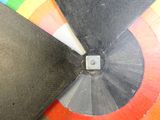 a close up of a skateboard with a colorful wheel in the background