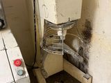 a dirty washer and dryer in the corner of a room
