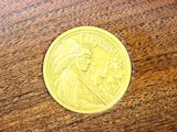 a close up of a coin on a wooden table