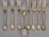 six silverware forks and spoons are lined up on a gray surface