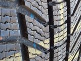 a close up of a tire on a road with a yellow stripe