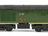 a green train car that is sitting on a white surface