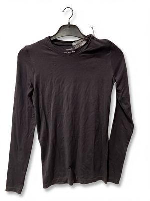 black long - sleeved shirt hanging on a hanger on a white wall