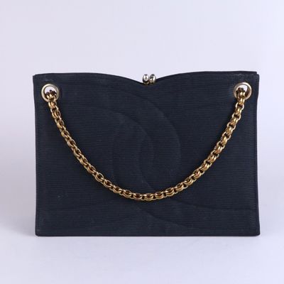 a close up of a black purse with a chain on it