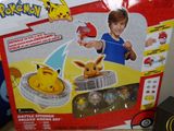 someone is holding a pokemon toy in front of a box