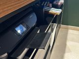 a printer sitting on top of a shelf in a store