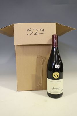 a bottle of wine sitting next to a cardboard box