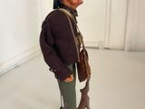 a figurine of a man with a dog on a pedestal