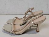 a close up of a pair of women ' s shoes on a white surface