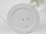 a white plate with a light bulb on top of it