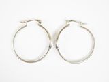 pair of silver hoop earrings on a white background