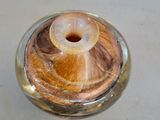 a glass jar with a wooden lid on a table