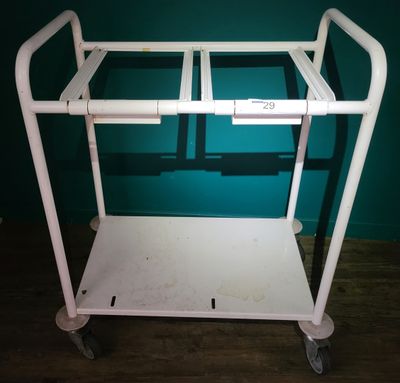 a white cart with a handle on it in a room