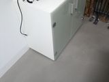 a telephone sitting on top of a cabinet in the corner of a room