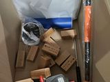 a cardboard box with a baseball bat, bat, and other items in it