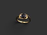 une bague en or sertie d'un diamant noir et de deux diamants blancs