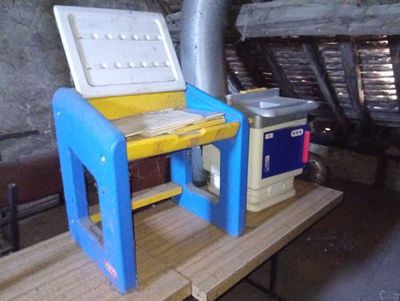 a blue and yellow table with a cooler on top of it