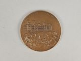 a gold coin with a picture of a castle on it