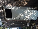 a picture of a broken refrigerator outside of a house