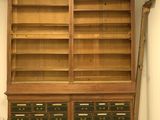 a large wooden bookcase with many drawers in it