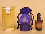 des flacons de parfum et un sac violet posés l'un à côté de l'autre sur une table