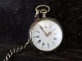 an old pocket watch with roman numerals on it