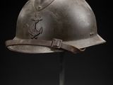an old helmet on a stand against a black background