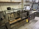 a picture of a commercial kitchen with a lot of counter space