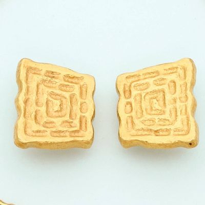 two pieces of bread sitting on a plate next to a pair of scissors