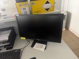 a computer monitor and keyboard on a desk