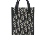 a brown and black handbag with a monogram pattern
