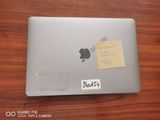 a sticker on the back of an apple laptop