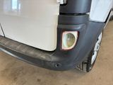the back end of a white truck with a red light on it ' s bumper