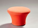 un tabouret orange posé sur une surface blanche