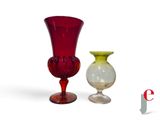 two vases sitting next to each other on a white surface