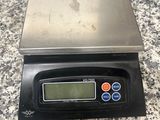 an electronic scale sitting on top of a granite counter top