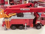 a toy fire truck with a ladder on top of it