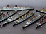 a lot of model ships that are sitting on a table