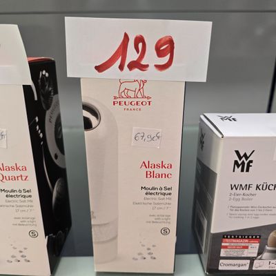 three boxes of hair products are on a shelf in a store