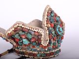 an image of a decorative bird made of beads and stones
