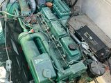 a large green engine sitting in the back of a truck