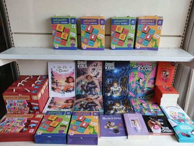 many children ' s books on a shelf next to each other