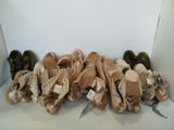 many pairs of shoes that are lined up on a shelf