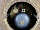 a clock that has a blue ball in the middle of it
