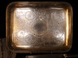 a silver tray sitting on top of a wooden table