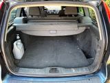 the back of a car with its trunk open and a water bottle in the trunk