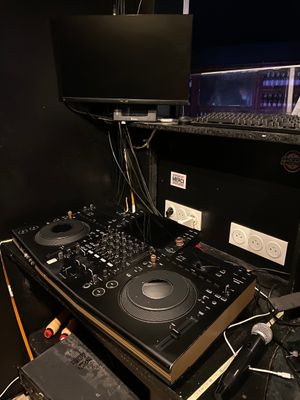 a computer and a dj controller on a desk