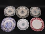 six plates with blue and white designs on them sitting on a black surface