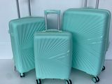 three pieces of luggage sitting on top of a white surface