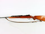 a rifle on a white background with a wooden handle